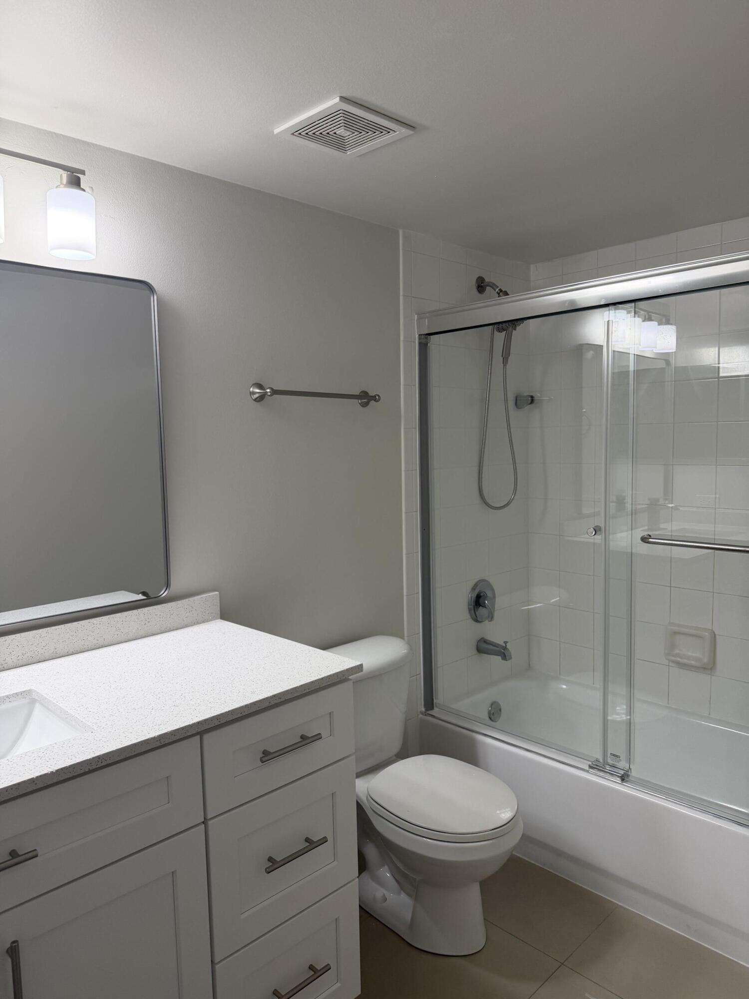 5031 Wiles Road, Unit 203 Coconut Creek, FL 33073 - Photo 19 of 24 a bathroom with a sink a toilet and shower