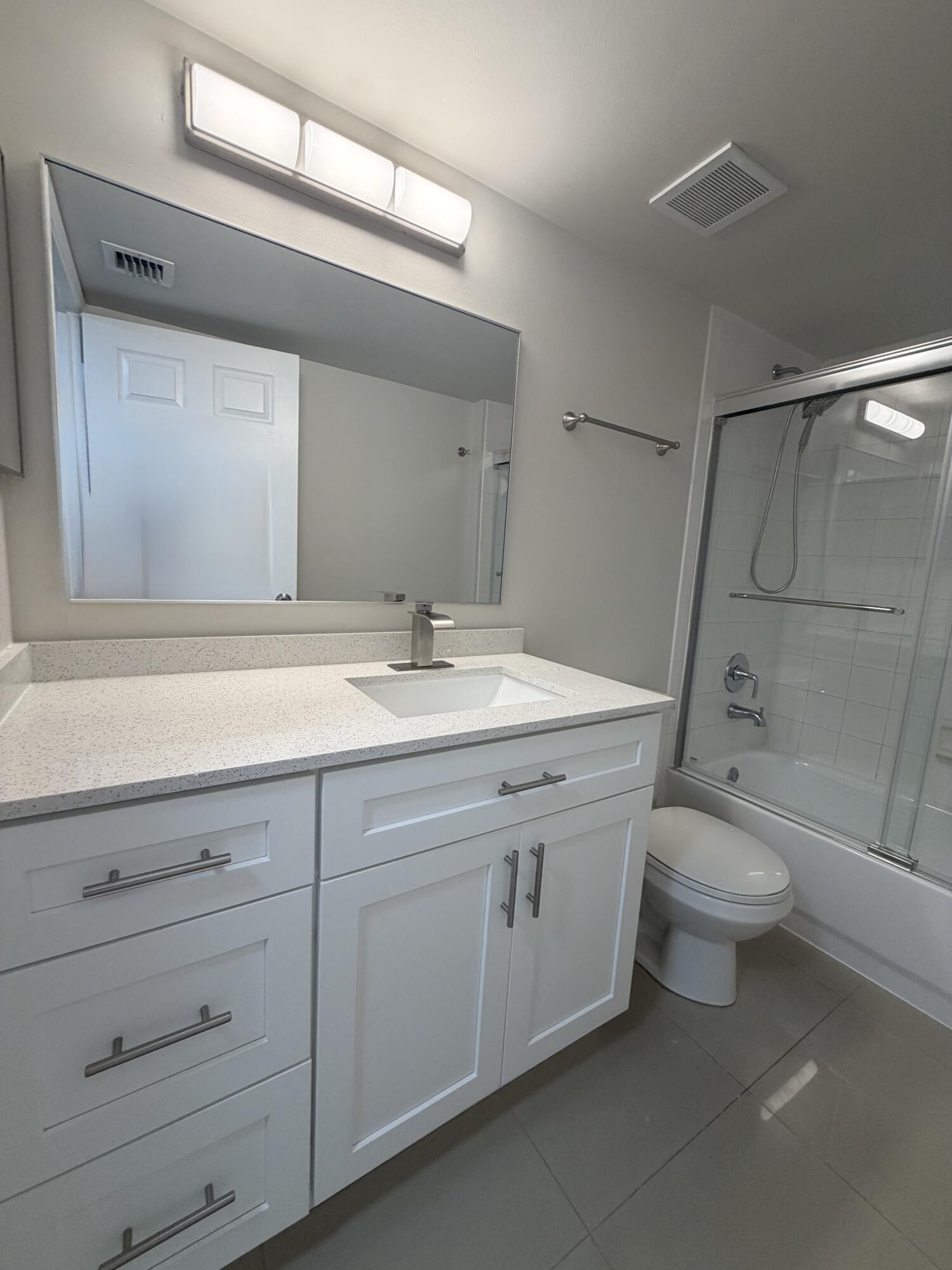 5031 Wiles Road, Unit 203 Coconut Creek, FL 33073 - Photo 24 of 24 a bathroom with a sink a toilet and shower