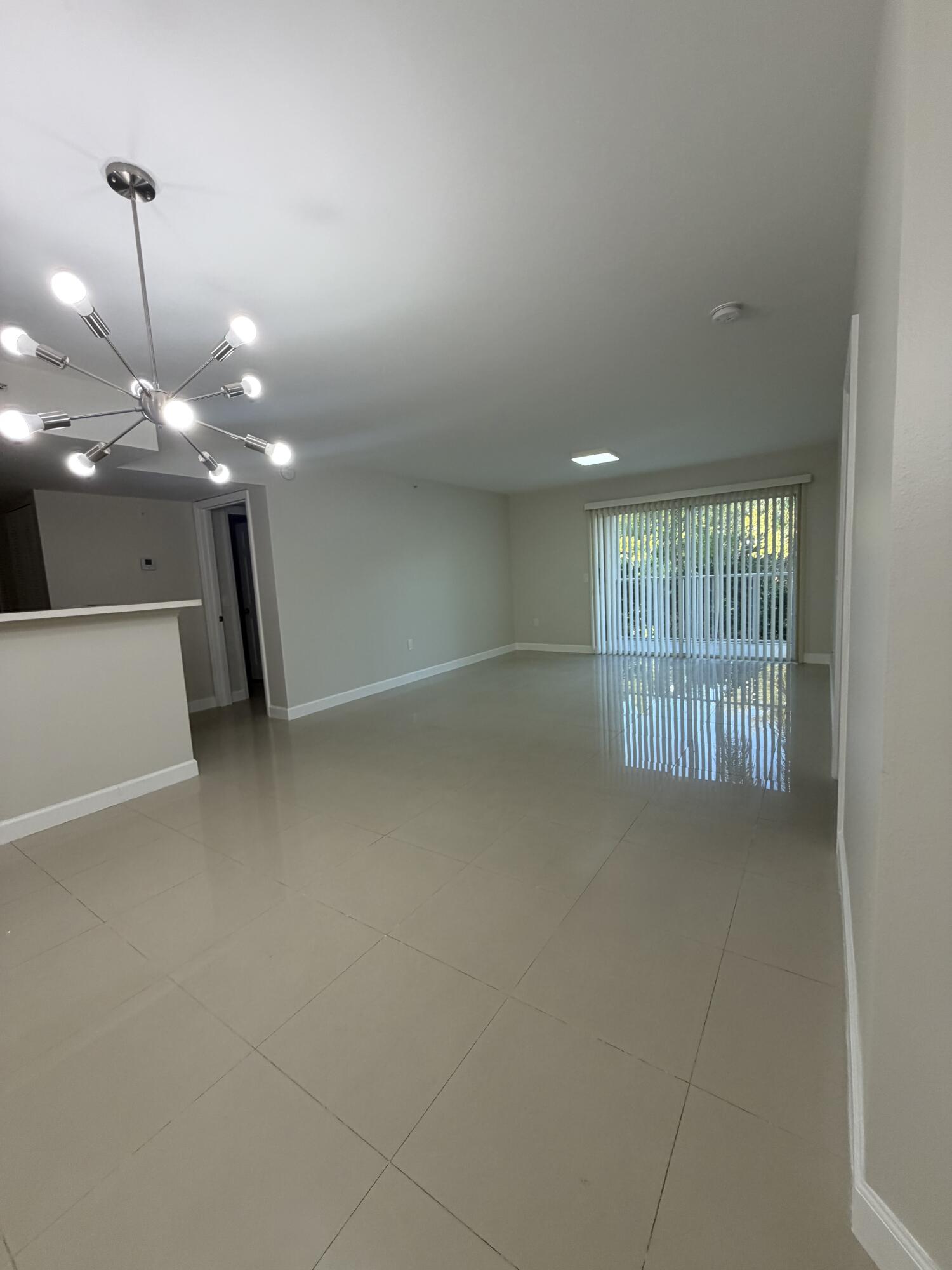 5031 Wiles Road, Unit 203 Coconut Creek, FL 33073 - Photo 4 of 24 a view of an empty room with a window