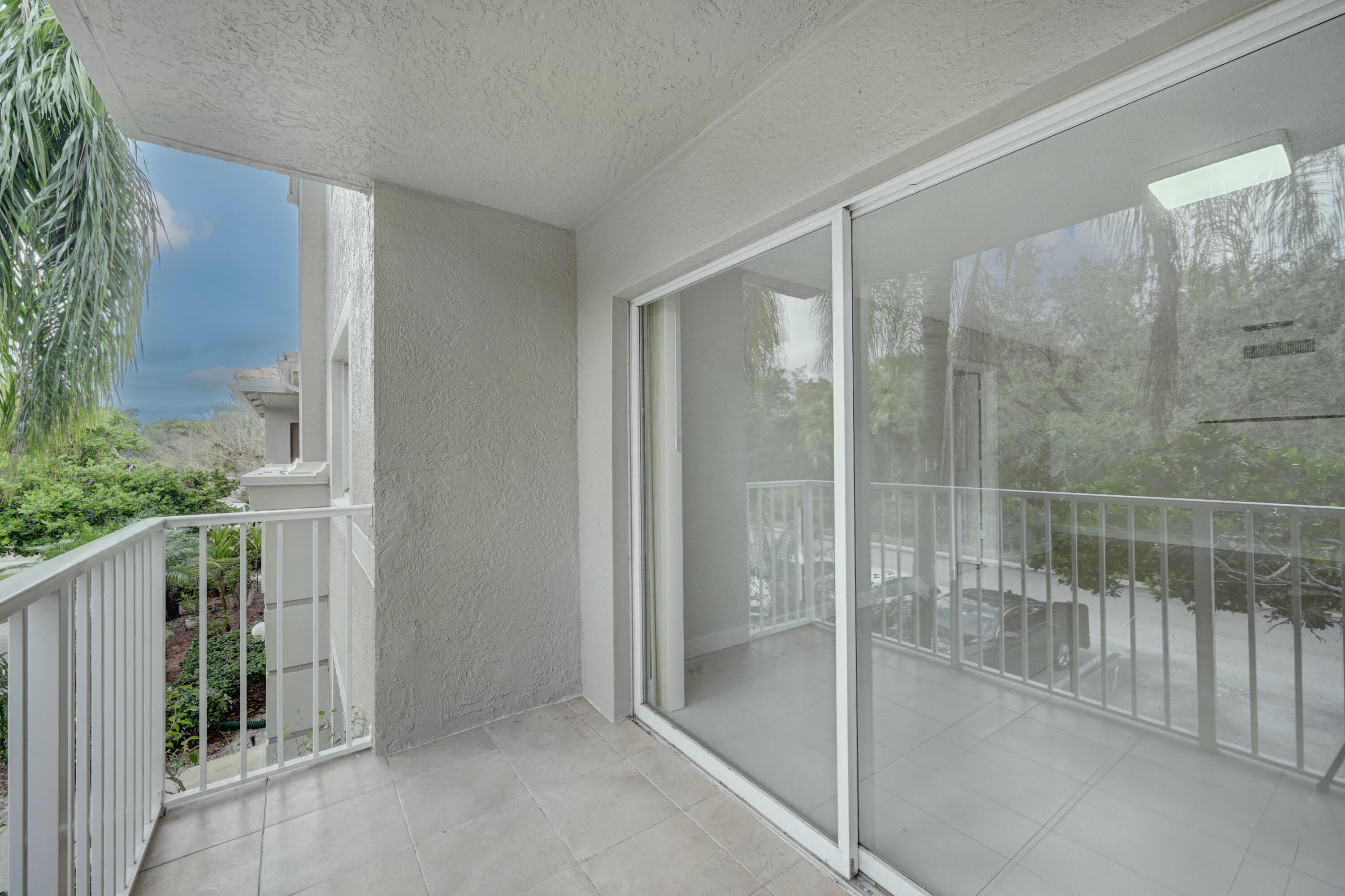 5031 Wiles Road, Unit 203 Coconut Creek, FL 33073 - Photo 5 of 24 a bathroom with a glass shower door
