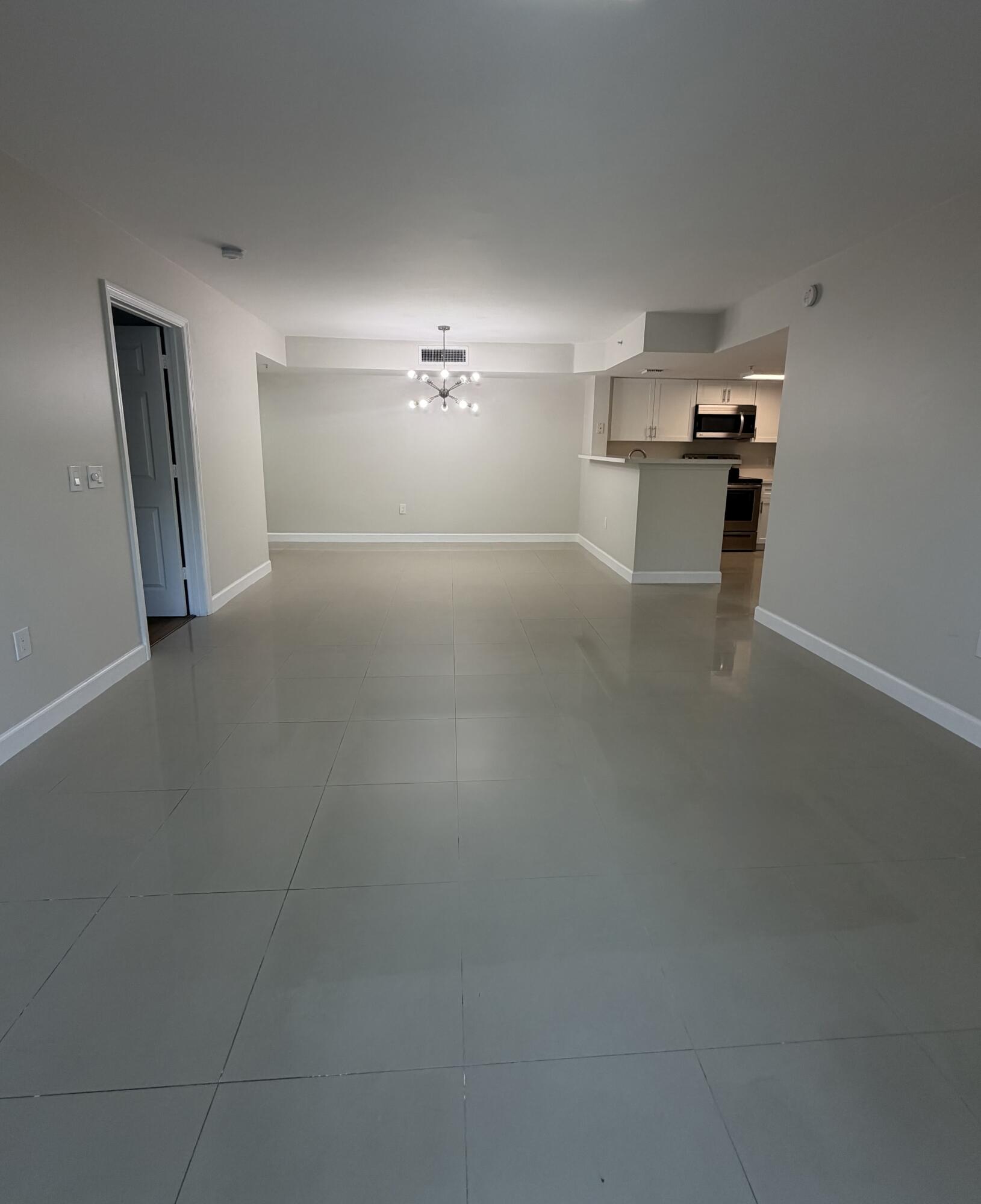 5031 Wiles Road, Unit 203 Coconut Creek, FL 33073 - Photo 6 of 24 a view of kitchen and empty room