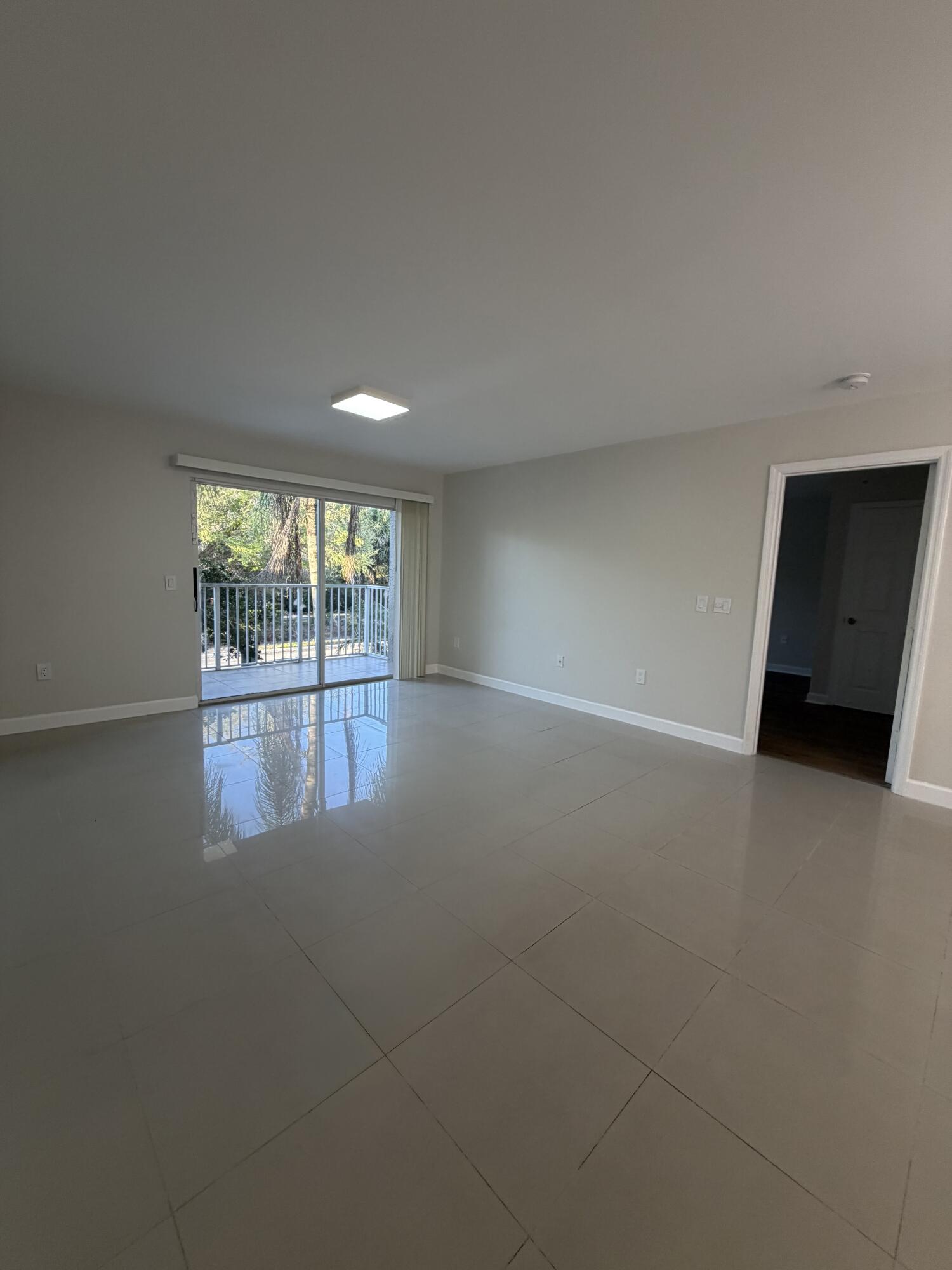 5031 Wiles Road, Unit 203 Coconut Creek, FL 33073 - Photo 7 of 24 a view of an empty room with a window