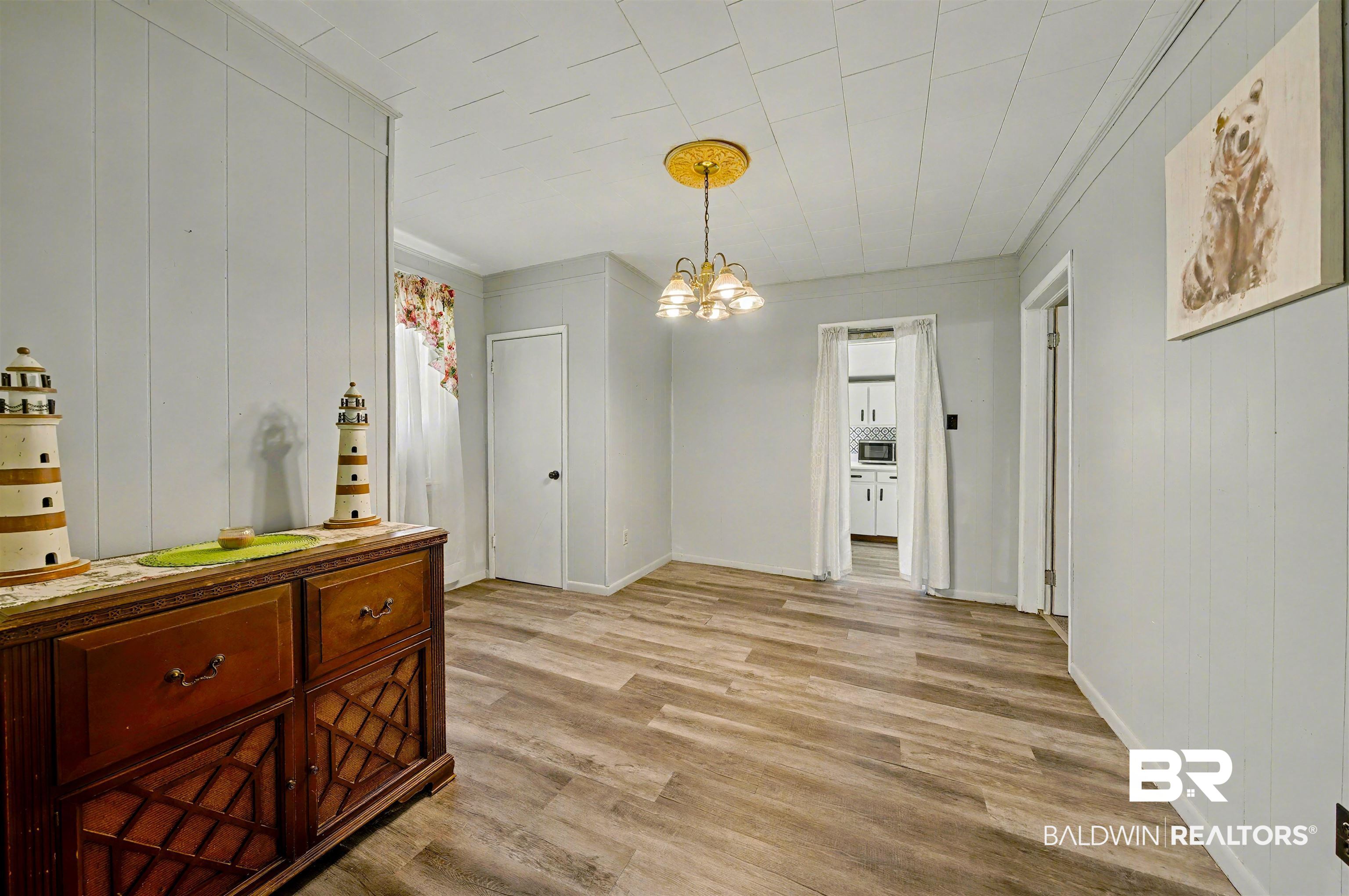 209 West Magnolia Avenue Foley, AL 36535 - Photo 12 of 23 Dining room featuring a chandelier, light wood finished floors, and ornamental molding