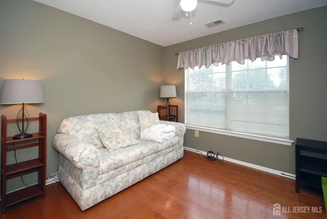 a bedroom with a bed lamp closet and window