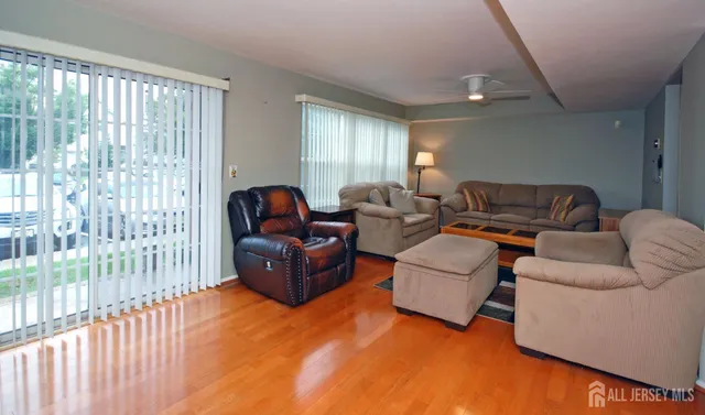 a living room with furniture and a lamp