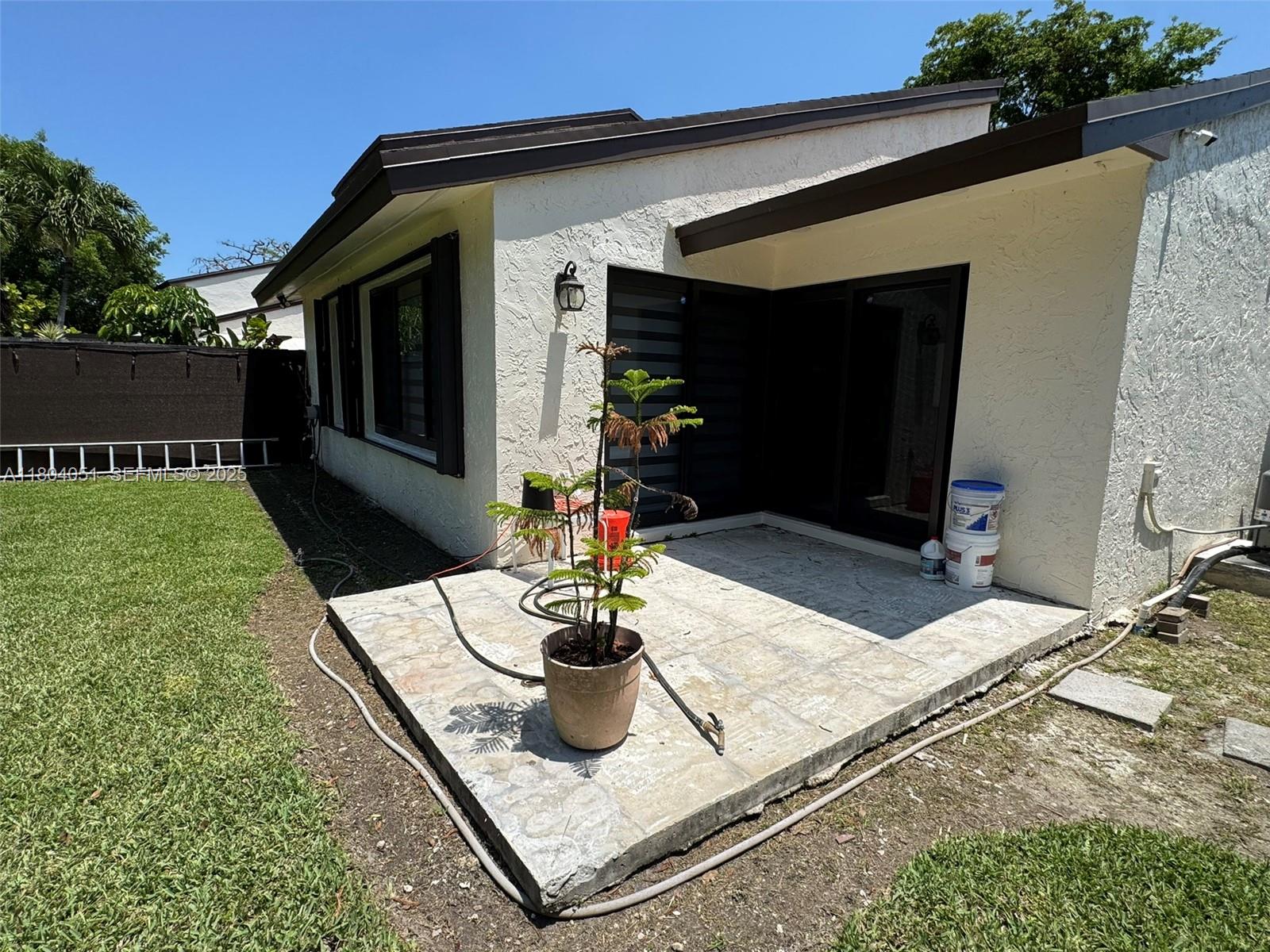 12721 Southwest 68th Terrace Miami, FL 33183 - Photo 11 of 31 a view of a patio with table and chairs potted plants