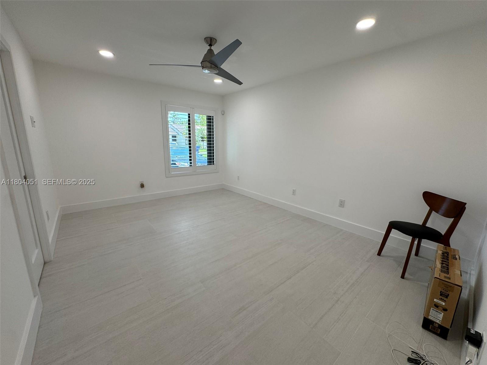 12721 Southwest 68th Terrace Miami, FL 33183 - Photo 23 of 31 an empty room with windows and ceiling fan