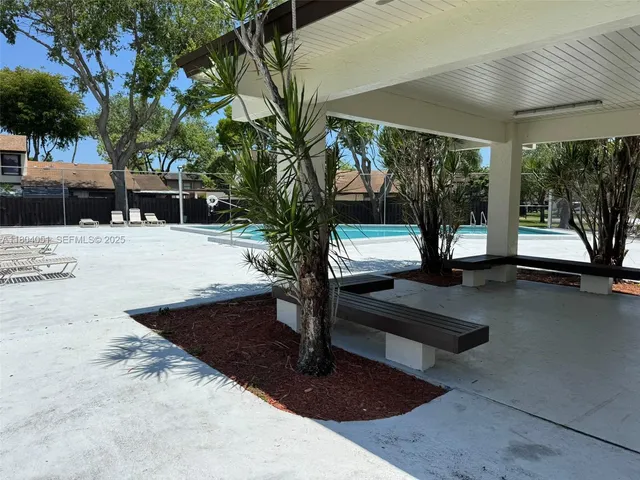 a swimming pool view with a outdoor seating