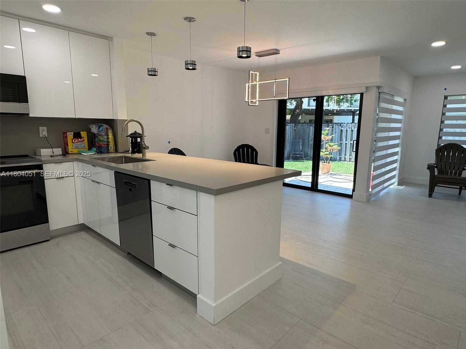 12721 Southwest 68th Terrace Miami, FL 33183 - Photo 5 of 31 a kitchen that has a lot of cabinets in it and wooden floor