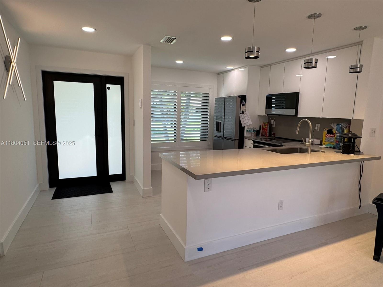 12721 Southwest 68th Terrace Miami, FL 33183 - Photo 7 of 31 a kitchen with stainless steel appliances granite countertop a sink a stove and a refrigerator