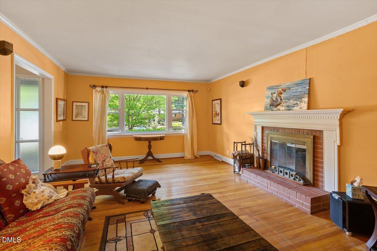 3107 Dixon Road Durham, NC 27707 - Photo 7 of 35 a living room with furniture and a fireplace