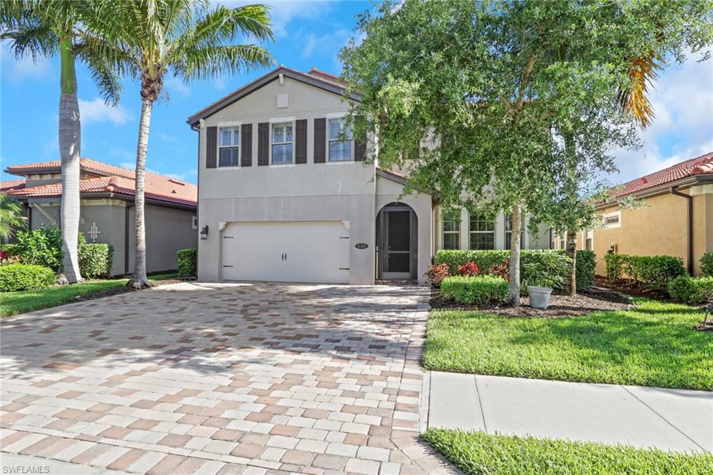 16309 Aberdeen Way Naples, FL 34110 - Photo 1 of 34 a front view of a house with a yard and garage