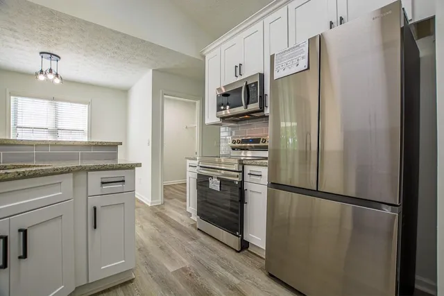 an empty room with wooden floor