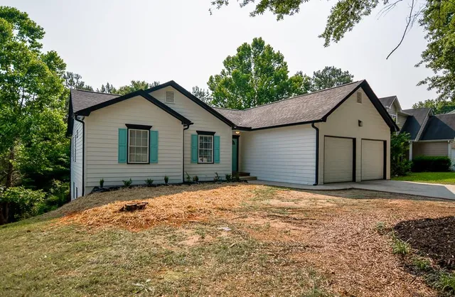 a front view of a house with garden