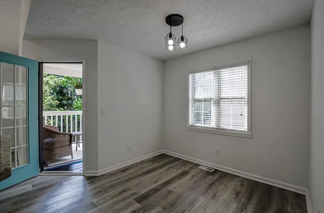 a bathroom with a granite countertop toilet a sink and a mirror