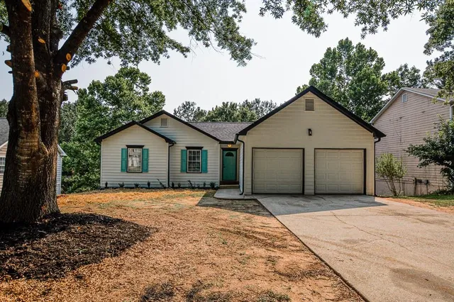 a view of a kitchen with refrigerator and wooden floor