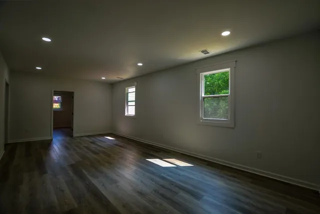 a bathroom with a toilet mirror and vanity