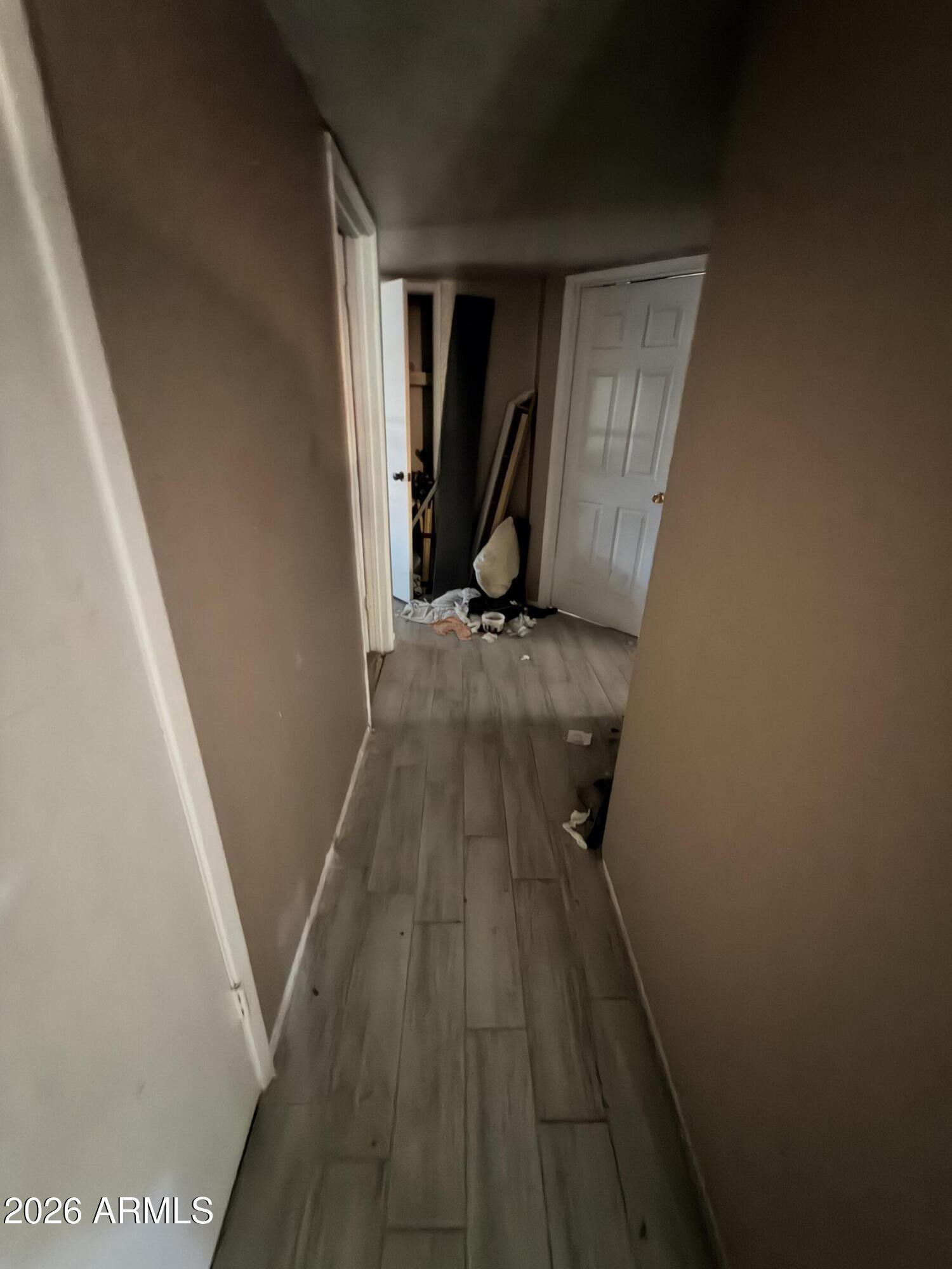 8057 West Pierson Street Phoenix, AZ 85033 - Photo 4 of 8 a view of a hallway with wooden floor and staircase