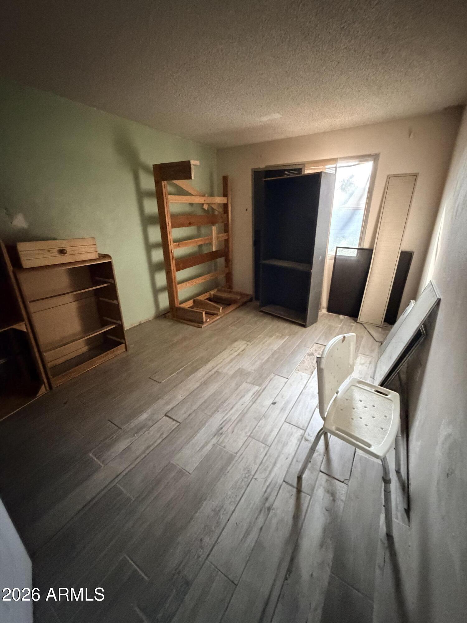 8057 West Pierson Street Phoenix, AZ 85033 - Photo 7 of 8 a bedroom with furniture and a window