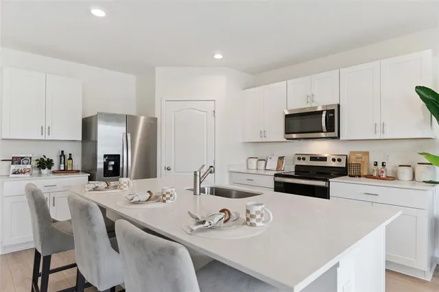 a kitchen with sink and view of living room