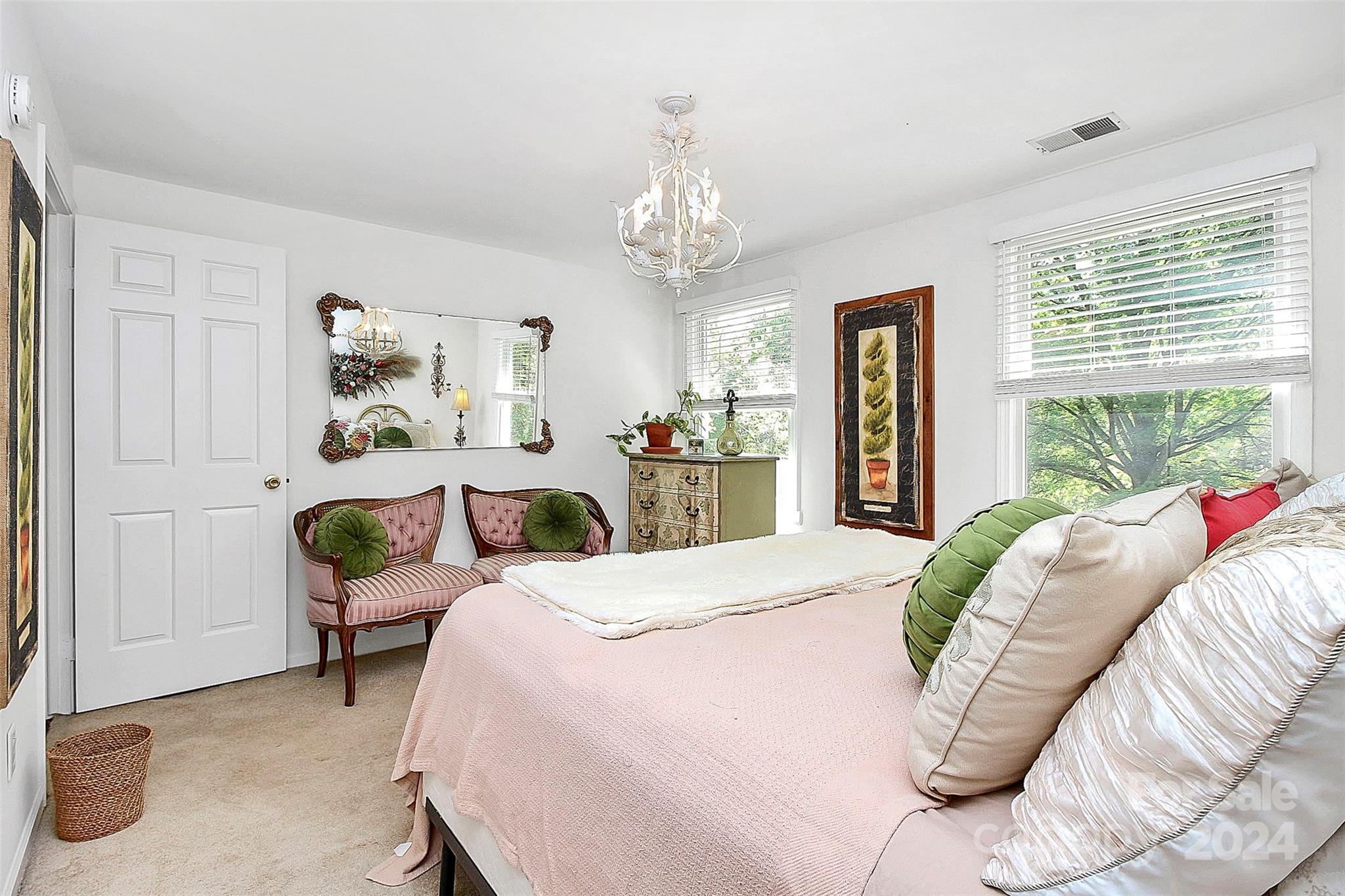 6225 Pella Road Charlotte, NC 28211 - Photo 6 of 7 a bedroom with a bed and a chandelier