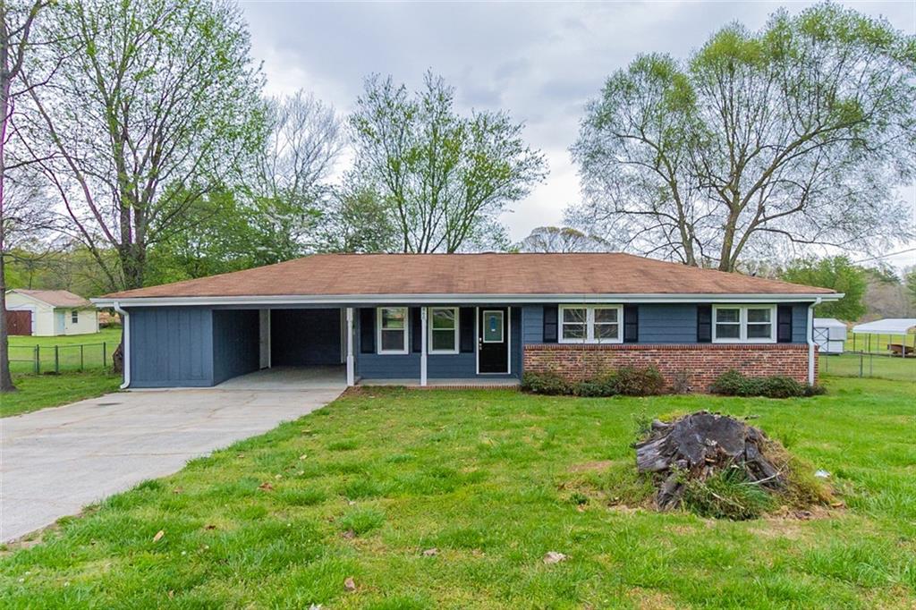 860 Tanner Road Dacula, GA 30019 - Photo 1 of 1 a view of a house with a garden and trees
