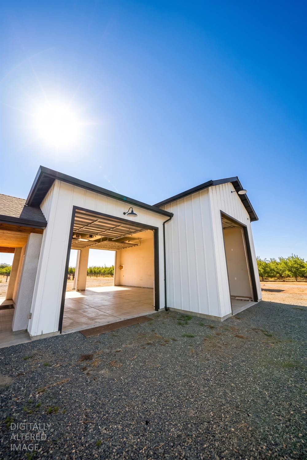 16464 Fox Road Lodi, CA 95240 - Photo 15 of 18 Detached shop/garage with oversized roll-up doors, providing excellent space for vehicles, equipment, hobbies, or additional storage.