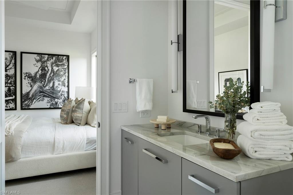 6704 Newport Road Naples, FL 34109 - Photo 24 of 47 a bathroom with a double vanity sink and a mirror