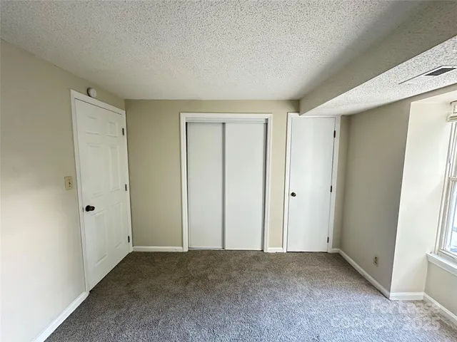 a view of an empty room and closet area