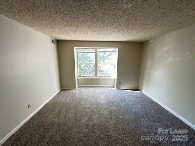 a view of an empty room and a window