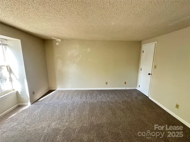 a view of an empty room and a window