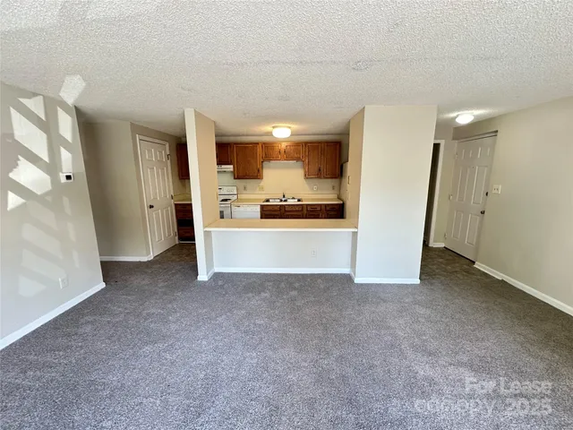 a view of a livingroom with a kitchen
