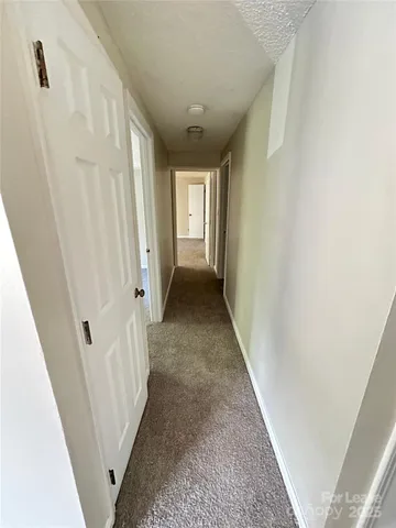 a view of a hallway with a white door