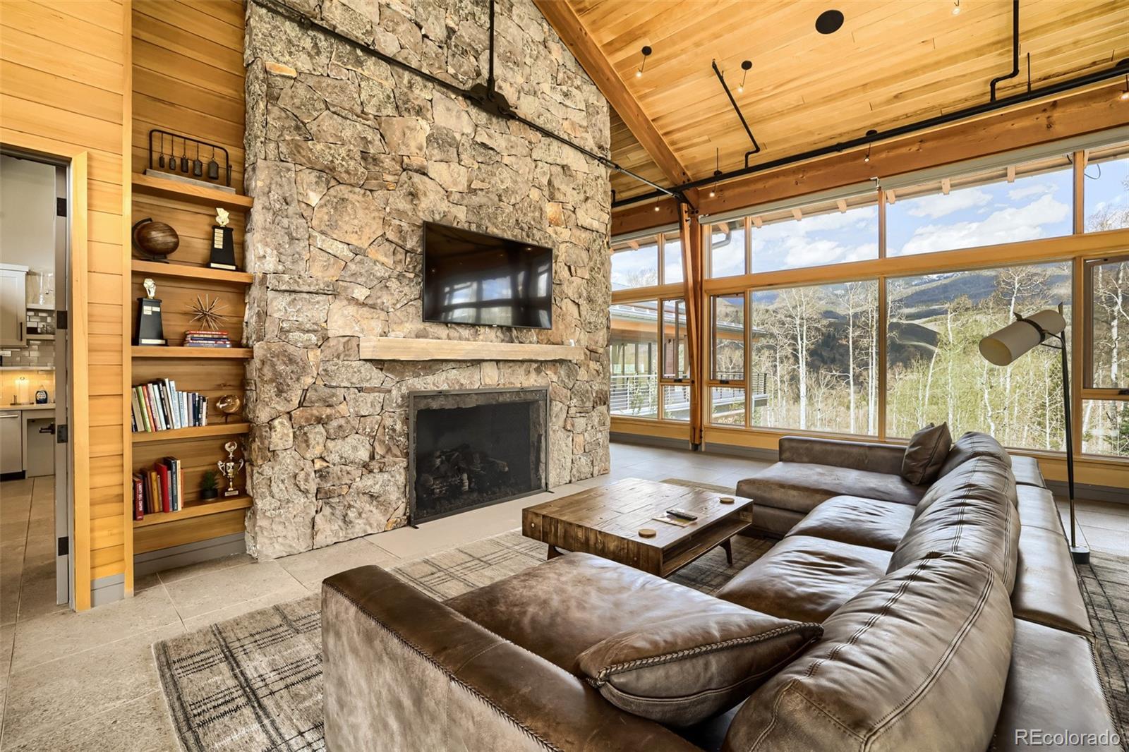 836 Maryland Creek Road Silverthorne, CO 80498 - Photo 35 of 49 a living room with furniture a flat screen tv and a fireplace