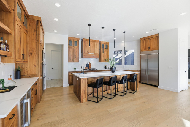 2197 Reserve Circle St. George, UT 84770 - Photo 2 of 57 Kitchen with wood finish cabinetry, glass fronted cabinets, an island with sink, built in fridge, and light wood-style flooring