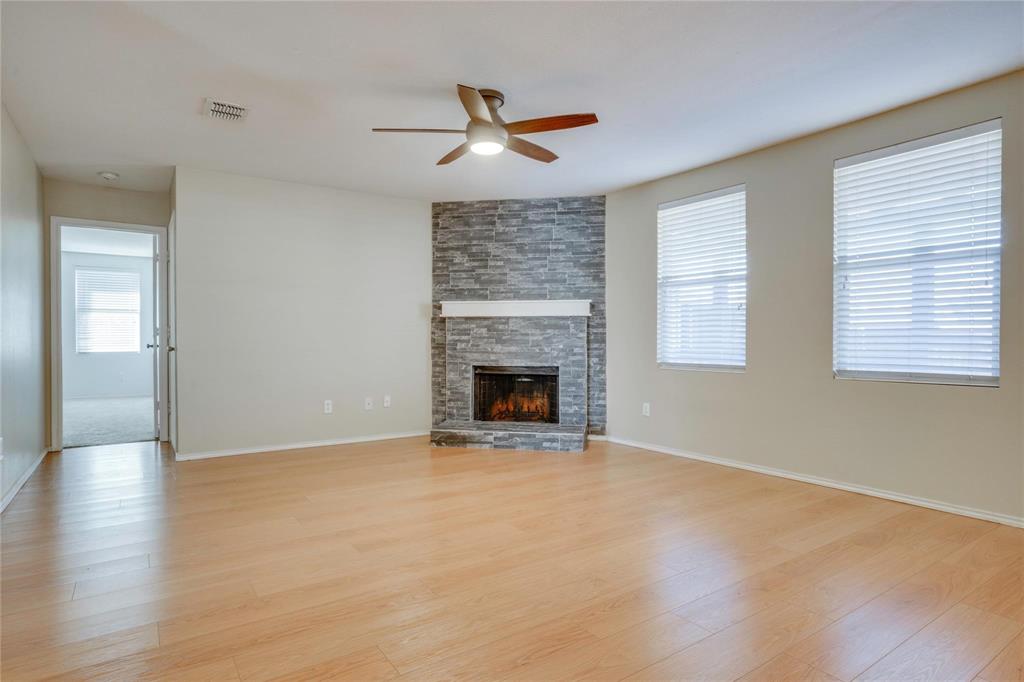 3054 Fallbrook Drive Rockwall, TX 75032 - Photo 4 of 15 a view of an empty room with wooden floor fireplace and a window