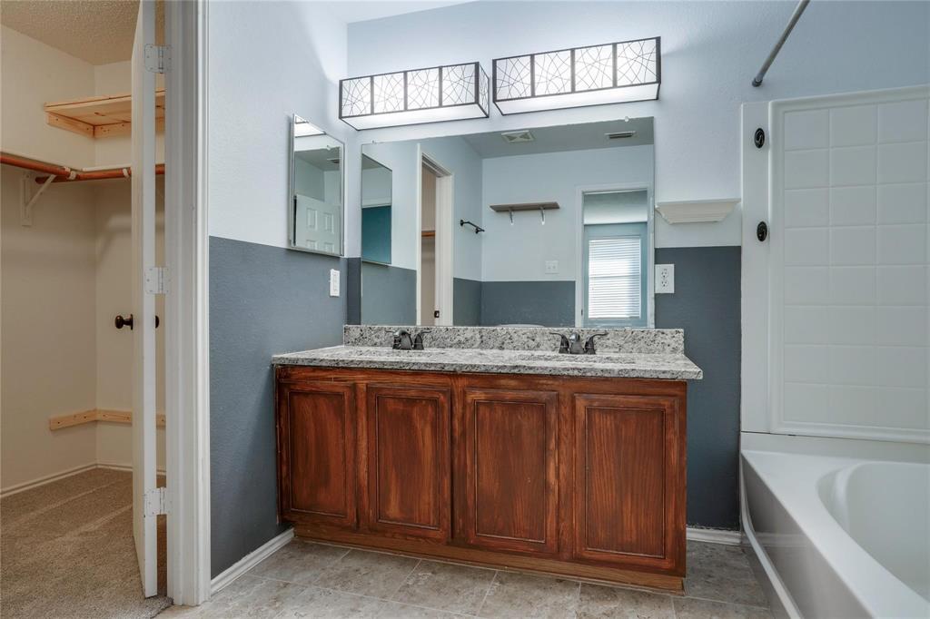 3054 Fallbrook Drive Rockwall, TX 75032 - Photo 10 of 15 a bathroom with a granite countertop sink and a bathtub
