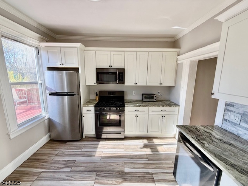 33 Ella Street Bloomfield, NJ 07003 - Photo 11 of 19 a kitchen with a refrigerator stove and sink