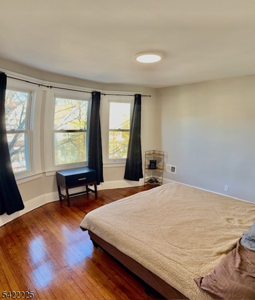 33 Ella Street Bloomfield, NJ 07003 - Photo 12 of 19 a bedroom with a bed table chair and a window