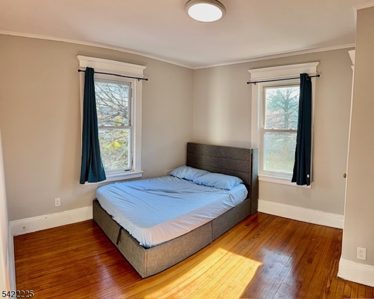 33 Ella Street Bloomfield, NJ 07003 - Photo 14 of 19 a bedroom with a bed and wooden floor