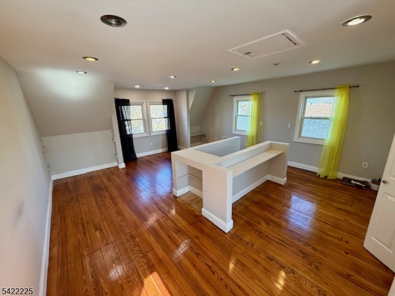 33 Ella Street Bloomfield, NJ 07003 - Photo 16 of 19 a spacious bedroom with a bed and wooden floor