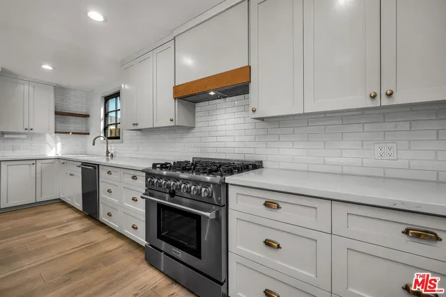 a kitchen with white cabinets and white appliances