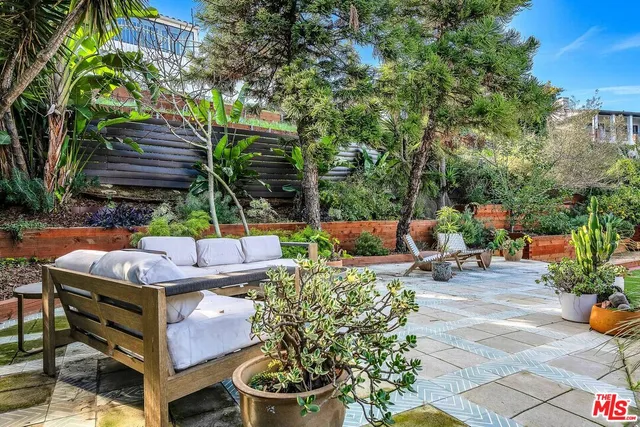 a view of a backyard with sitting area and furniture