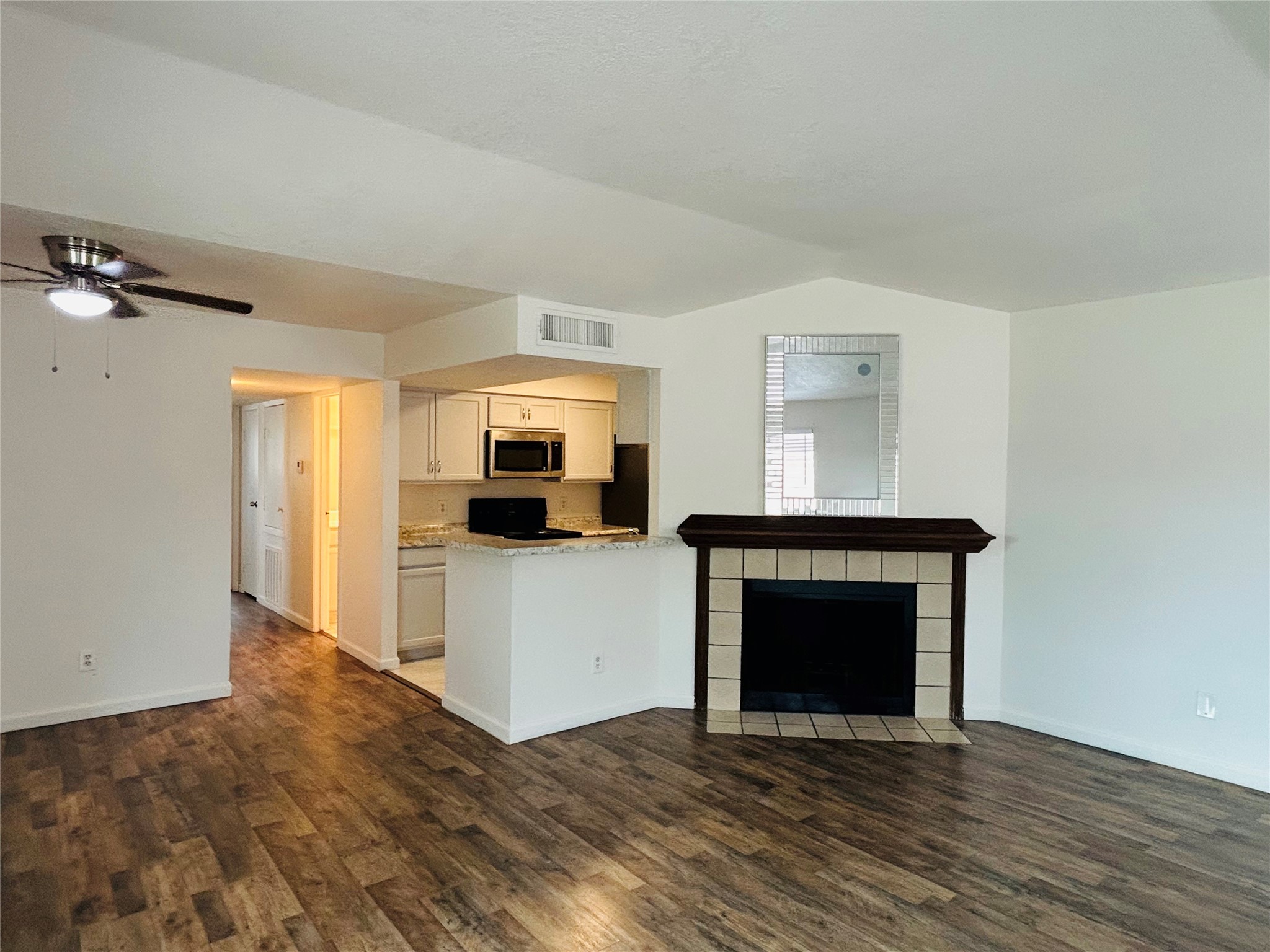 a living room with a fireplace and a flat screen tv