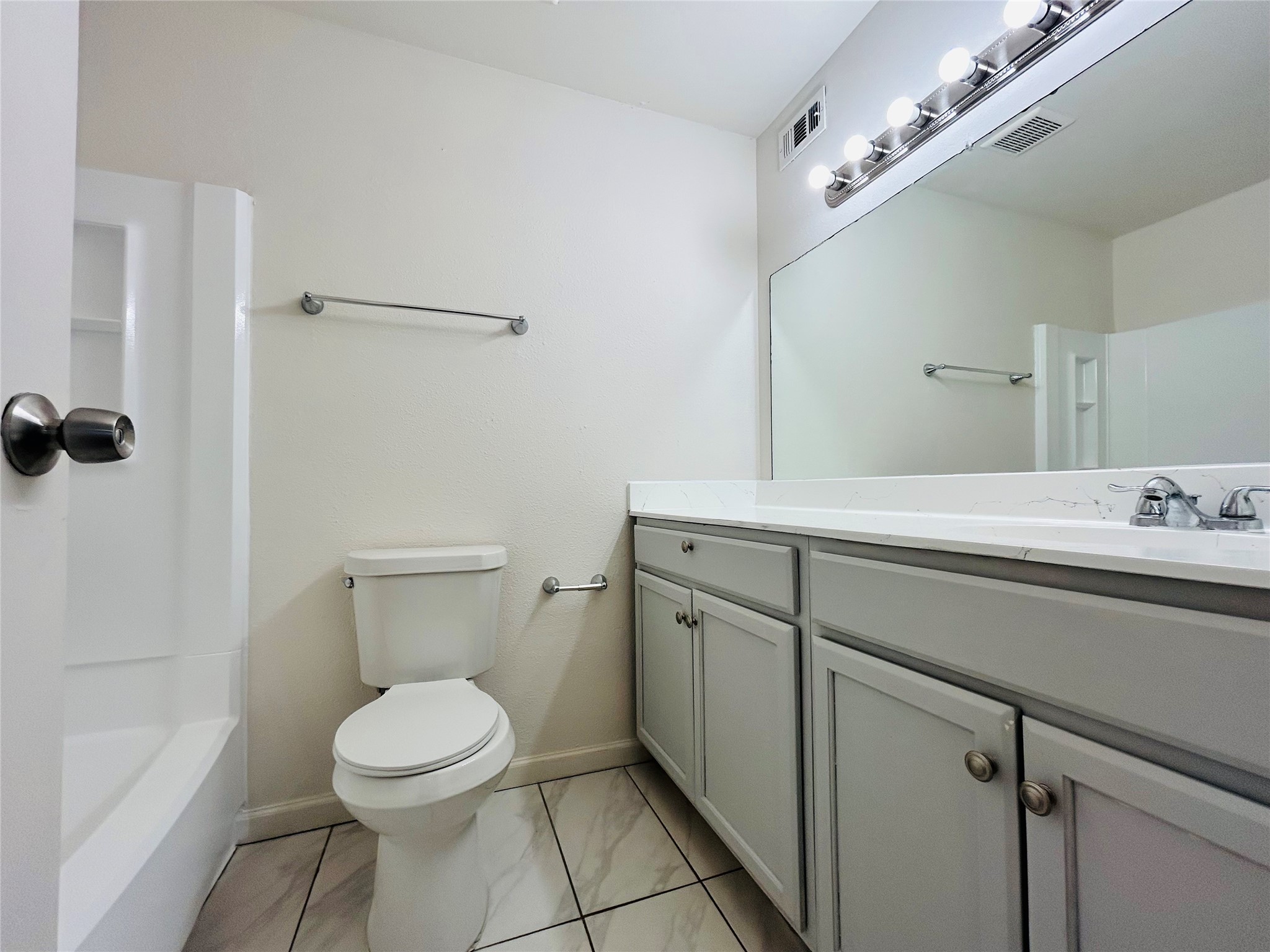8030 Sands Point Drive, Unit D Houston, TX 77036 - Photo 11 of 24 a bathroom with a toilet sink and mirror