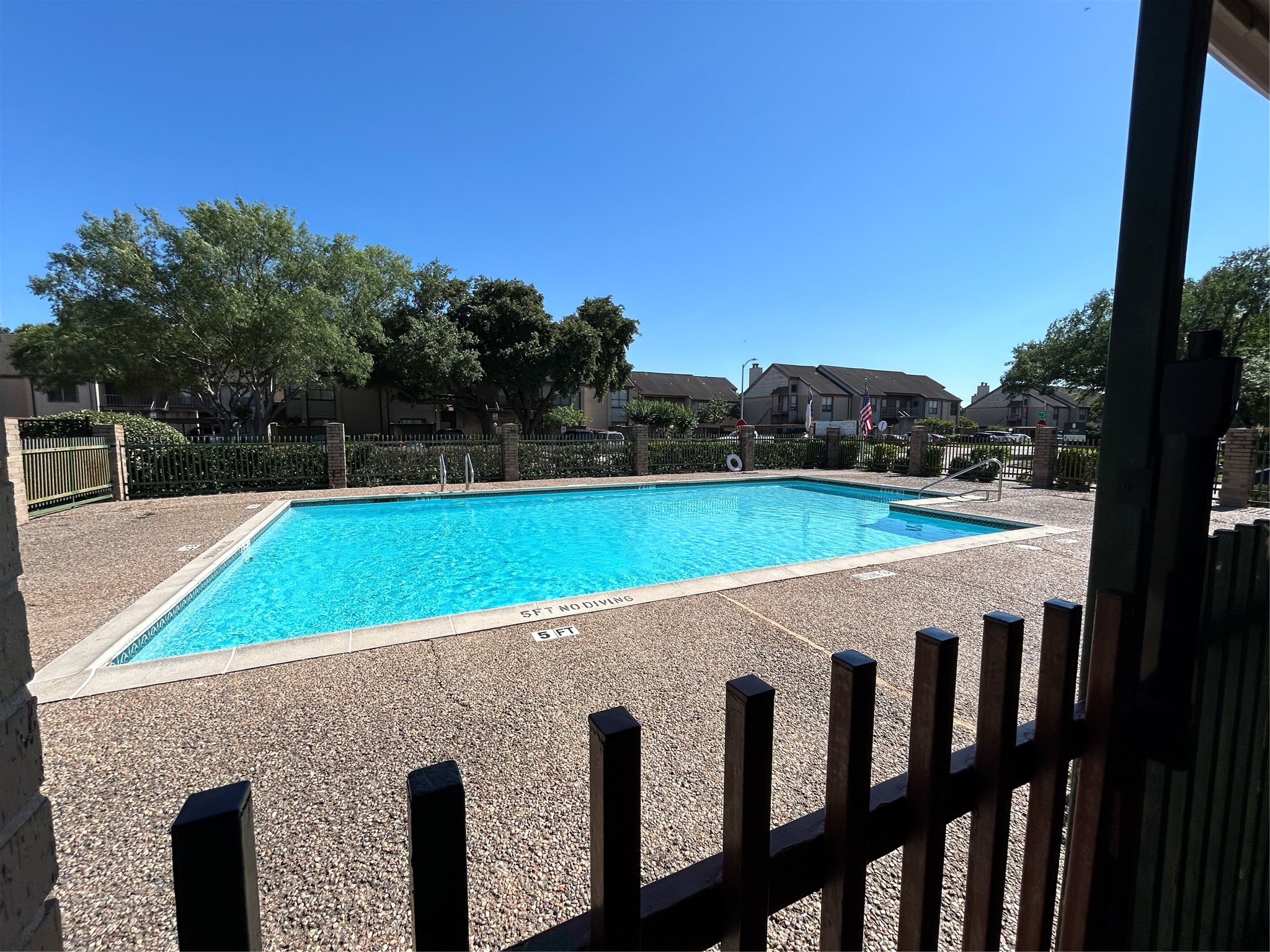 8030 Sands Point Drive, Unit D Houston, TX 77036 - Photo 11 of 14 a view of a swimming pool with a yard