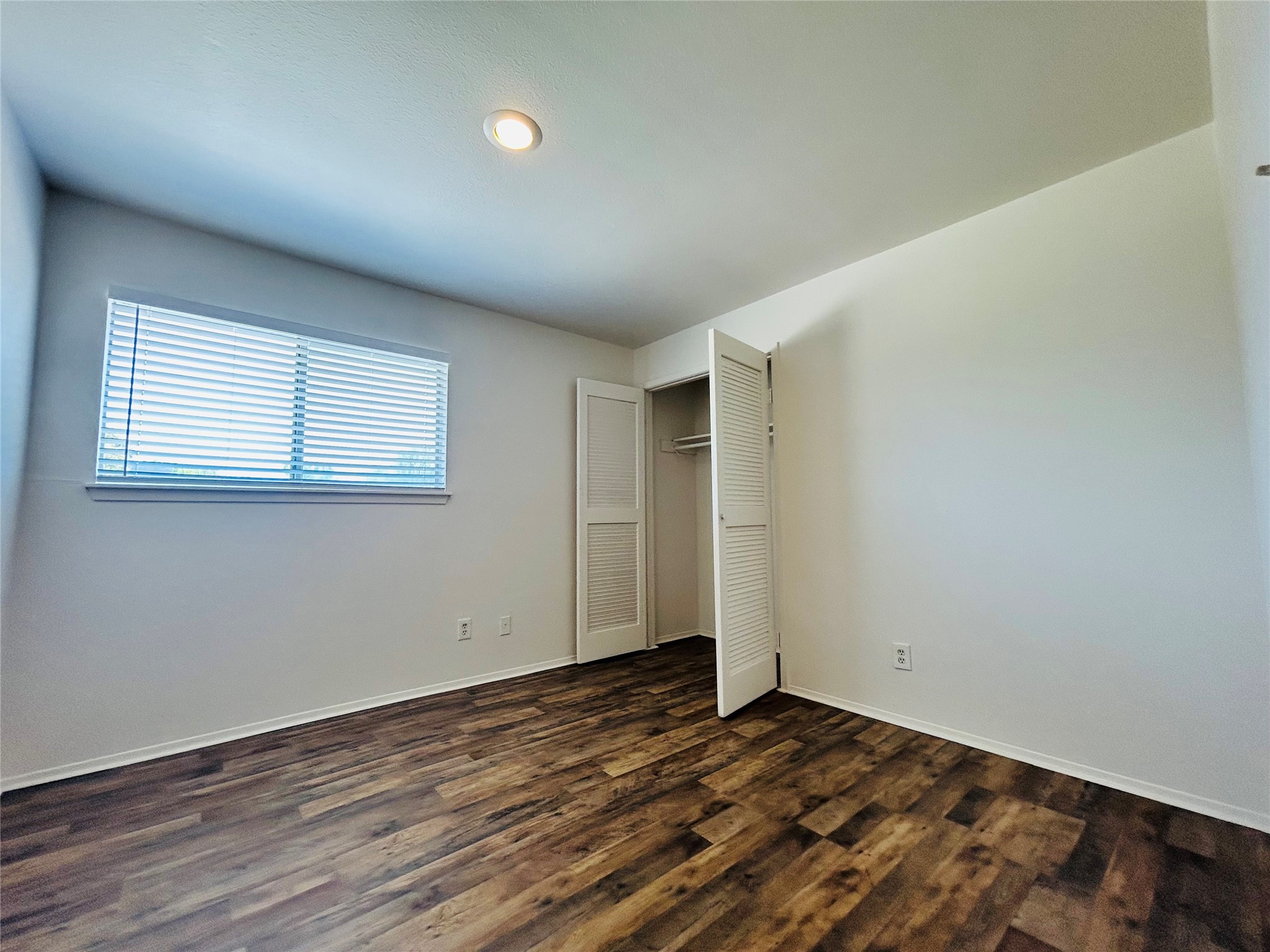8030 Sands Point Drive, Unit D Houston, TX 77036 - Photo 12 of 24 an empty room with wooden floor and windows