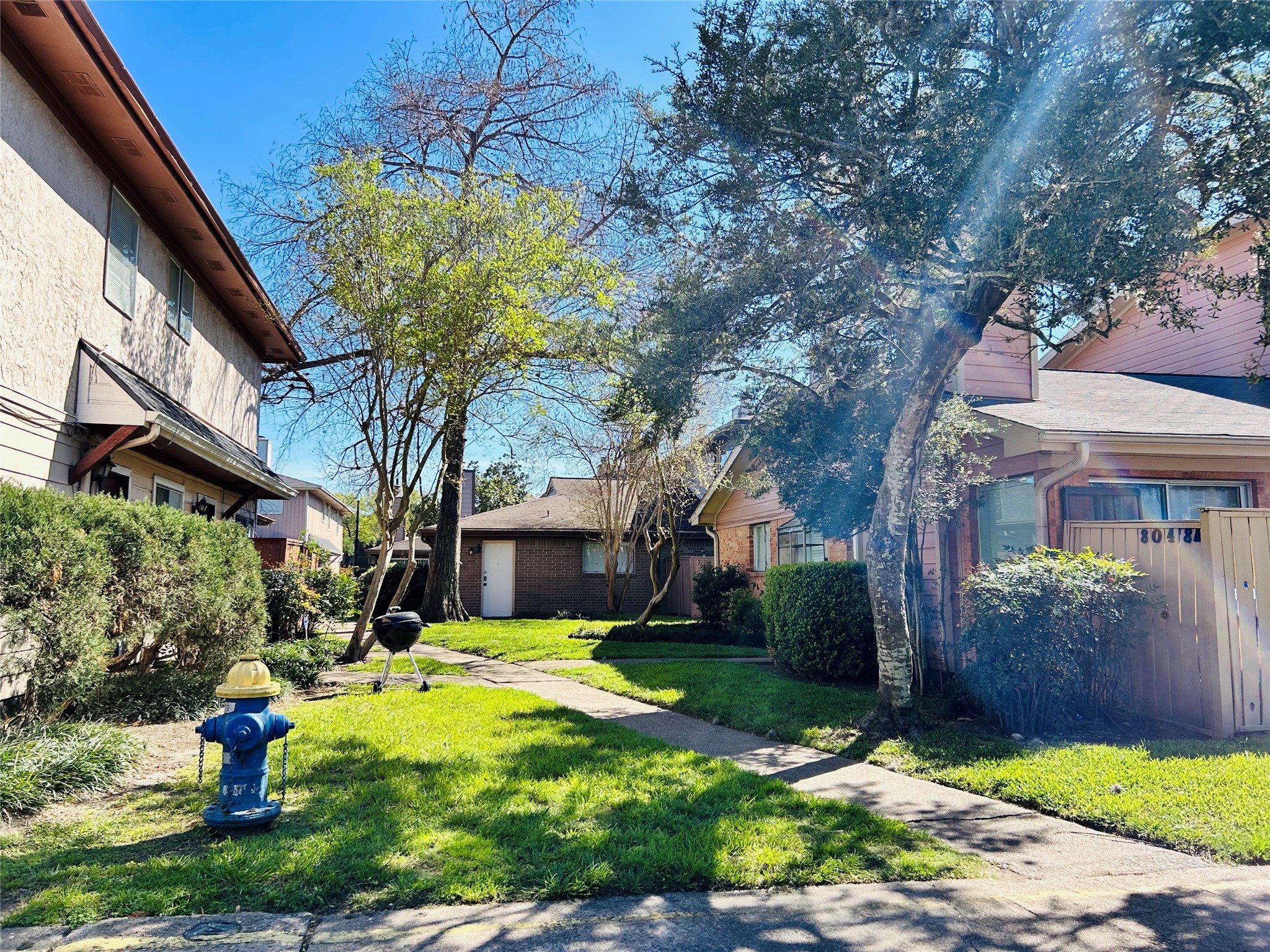 8030 Sands Point Drive, Unit D Houston, TX 77036 - Photo 22 of 24 a front view of a house with garden