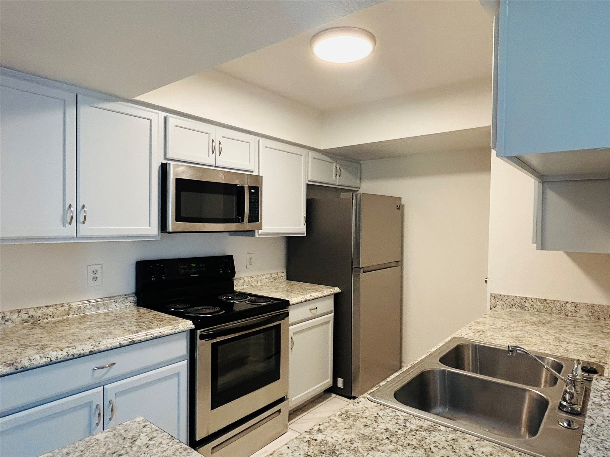 8030 Sands Point Drive, Unit D Houston, TX 77036 - Photo 3 of 14 a kitchen with granite countertop a sink stove and refrigerator