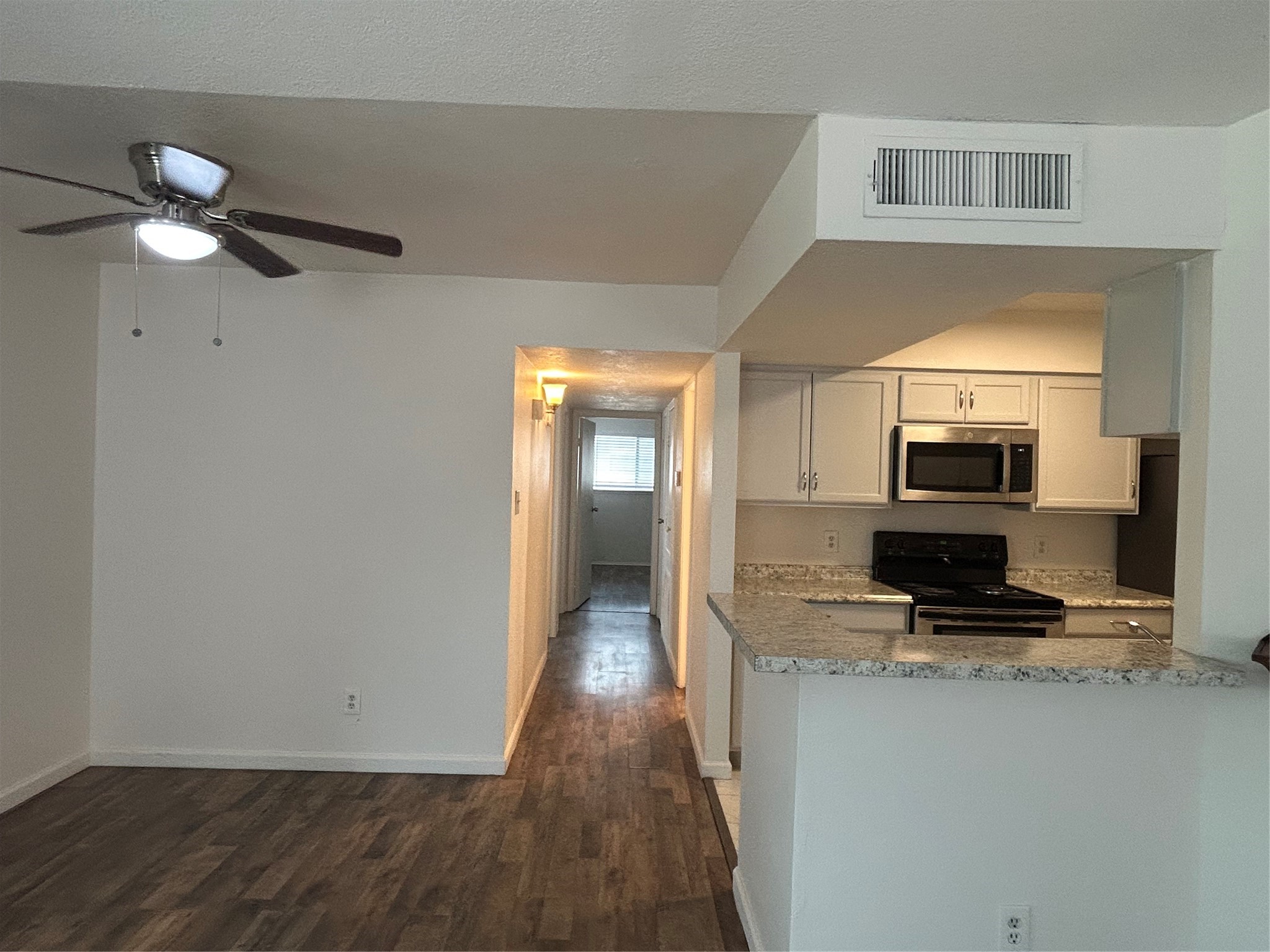 8030 Sands Point Drive, Unit D Houston, TX 77036 - Photo 5 of 14 a view of a kitchen from the hallway